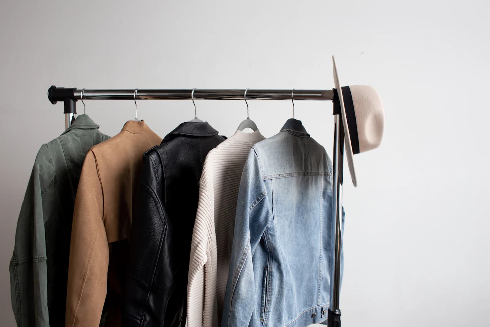 Leather and suede jackets hanging on a garment rack