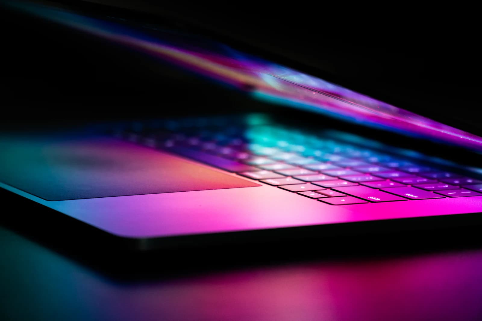 Laptop keyboard glowing in colorful light