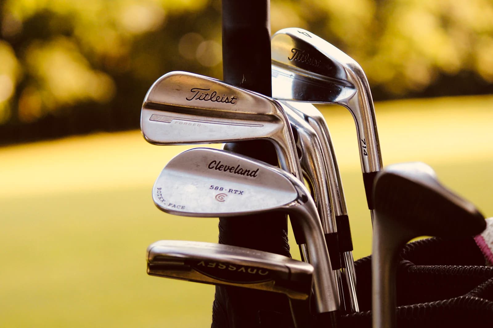 Set of golf irons and wedges standing in a golf bag